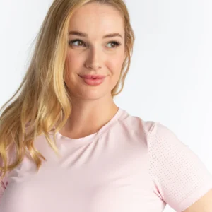 A woman in pink shirt posing for the camera.